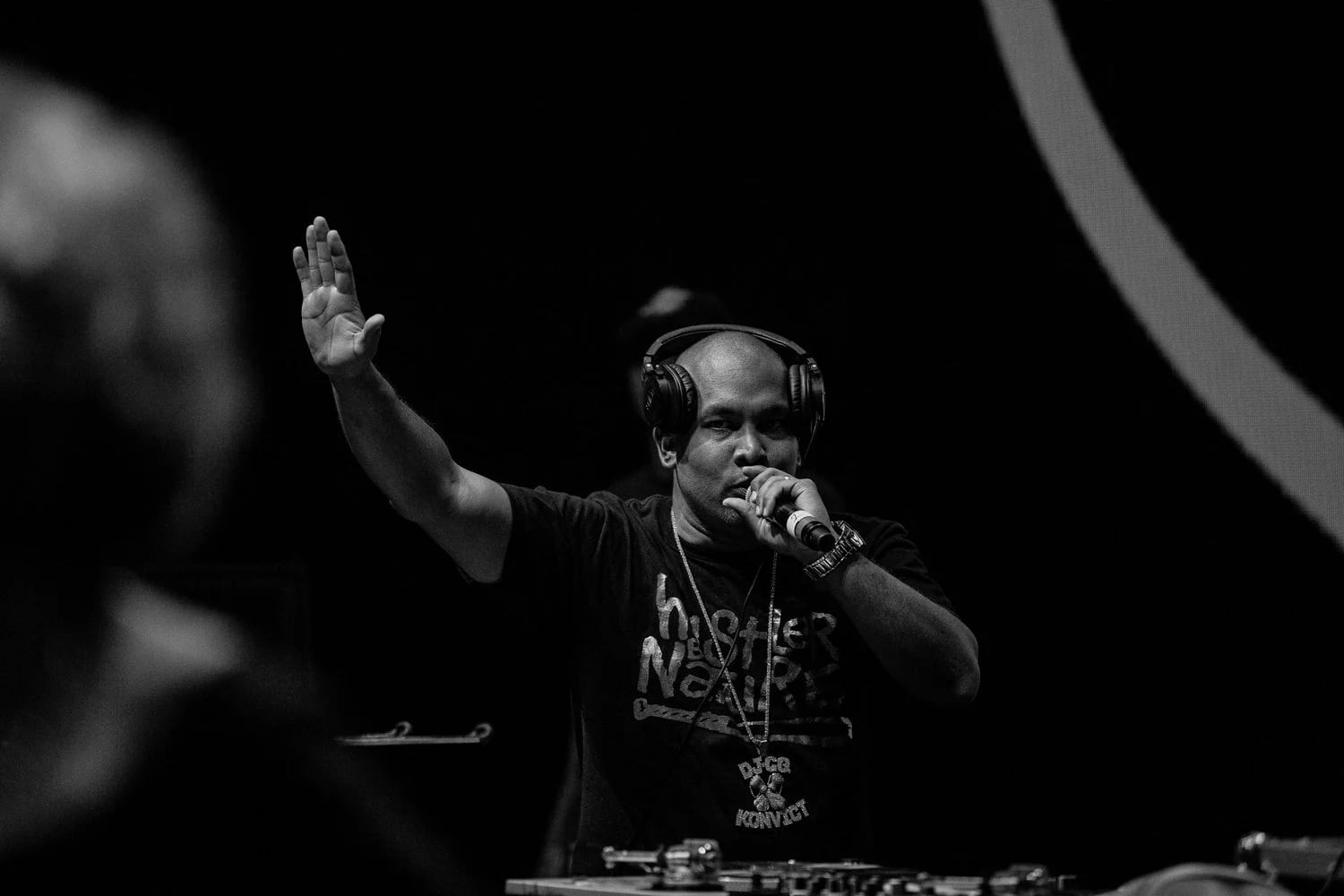 DJ GQ performing, hand raised to the crowd